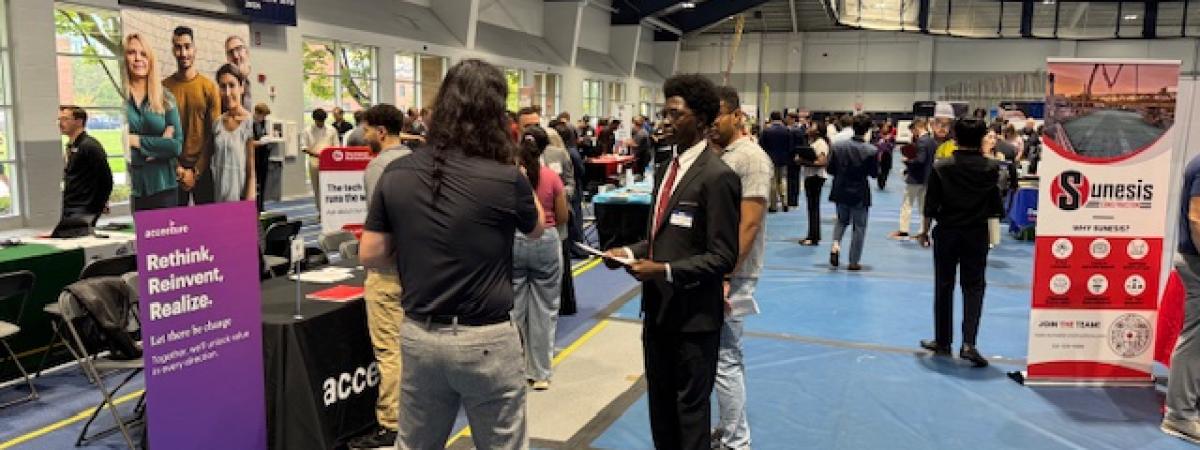 Students chatting with recruiter at career fair
