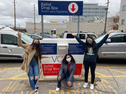 3 students in front of Cuyahoga County Ballot drop box