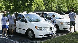 Groups of students around two CCEL vans