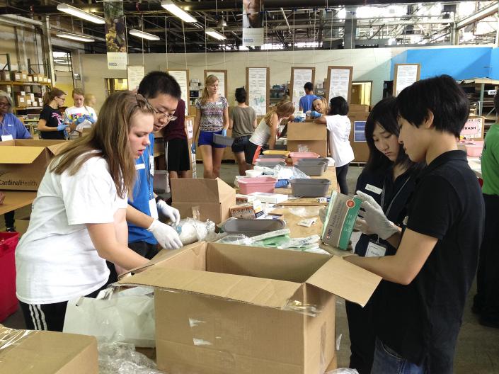 Students packing boxes of medical supplies