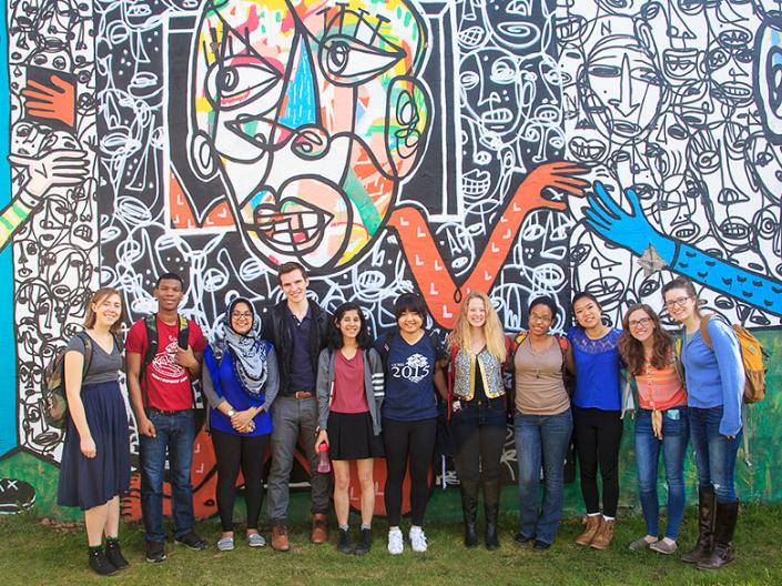 CCEL Fellow students standing in front of a mural