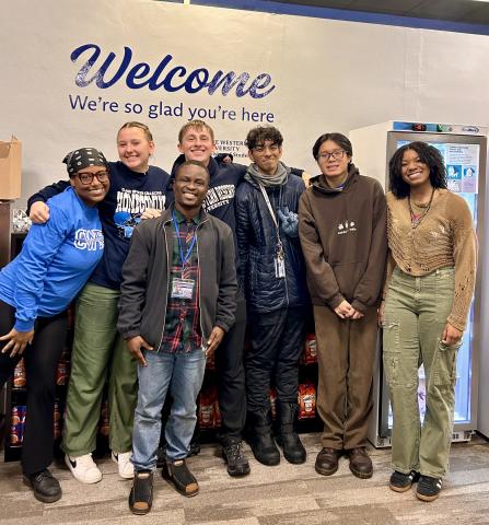 Seven student workers standing in front of the pantry