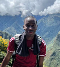 A man standing in front of mountains