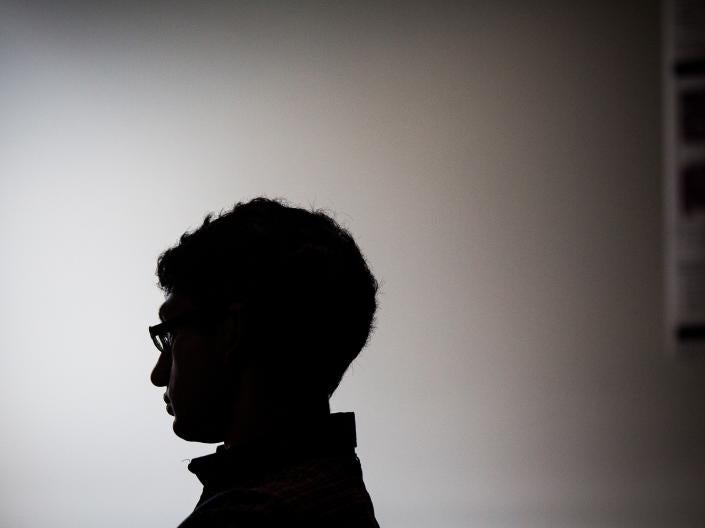 Darkened silhouette of a person facing to the left
