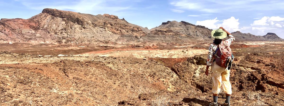 Student in Kenya has back to camera looks over horizon