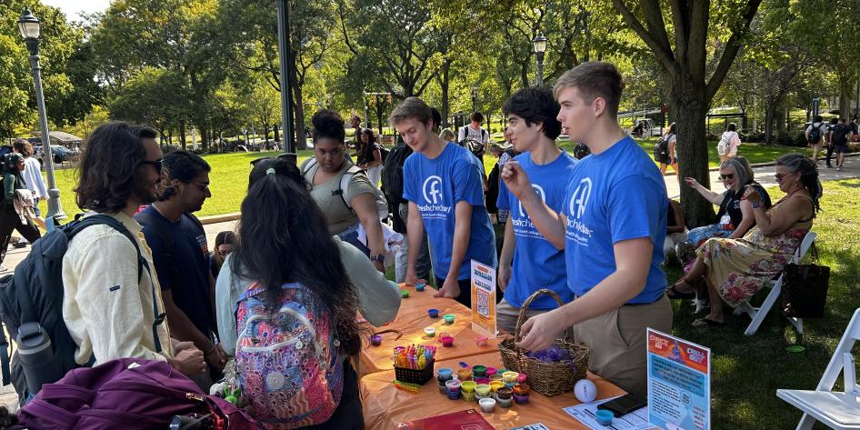 Students standing at a booth