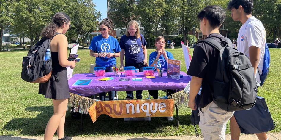 Students standing by a booth