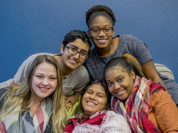 A group of students pose in the Office of Multicultureal Affairs space