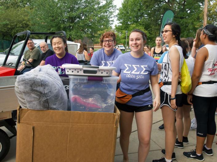 Group of students smiling as they move in to CWRU