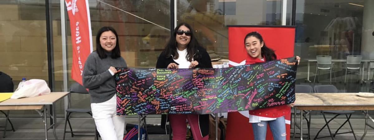 RHA event with three women holding a banner