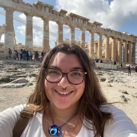 Student smiling in front of the Parthenon
