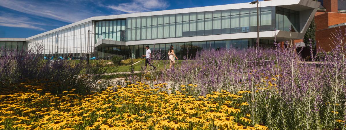 The outside of TVUC in the spring with flowers and a blue sky
