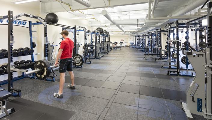 Student lifting weights in Wyant Athletic Center