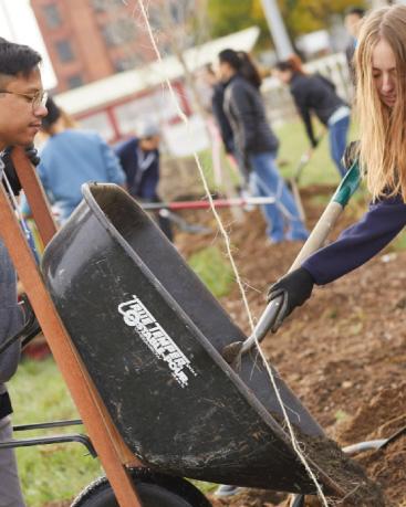 Two students helping at a community garden