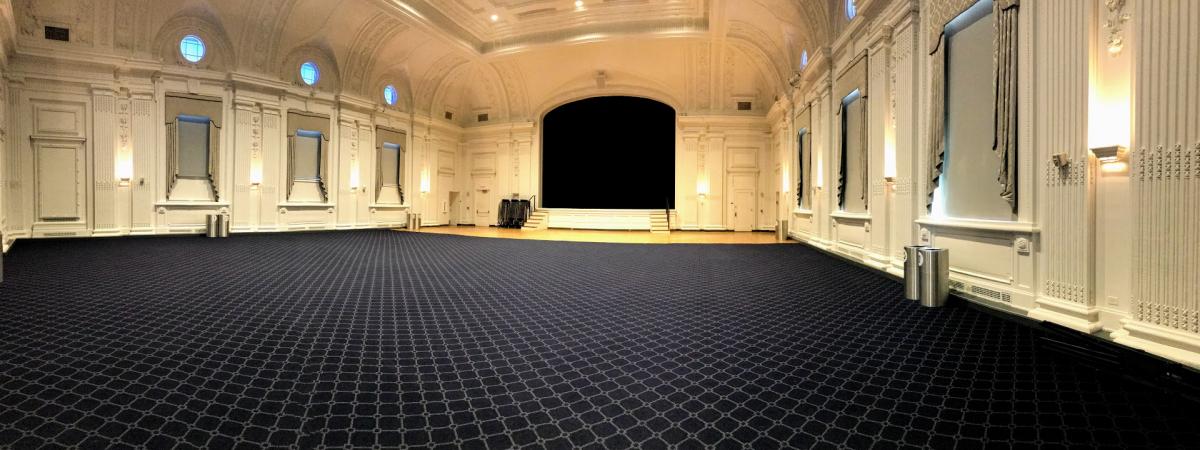 An empty view of Excelsior Ballroom with its large open floor and stage.