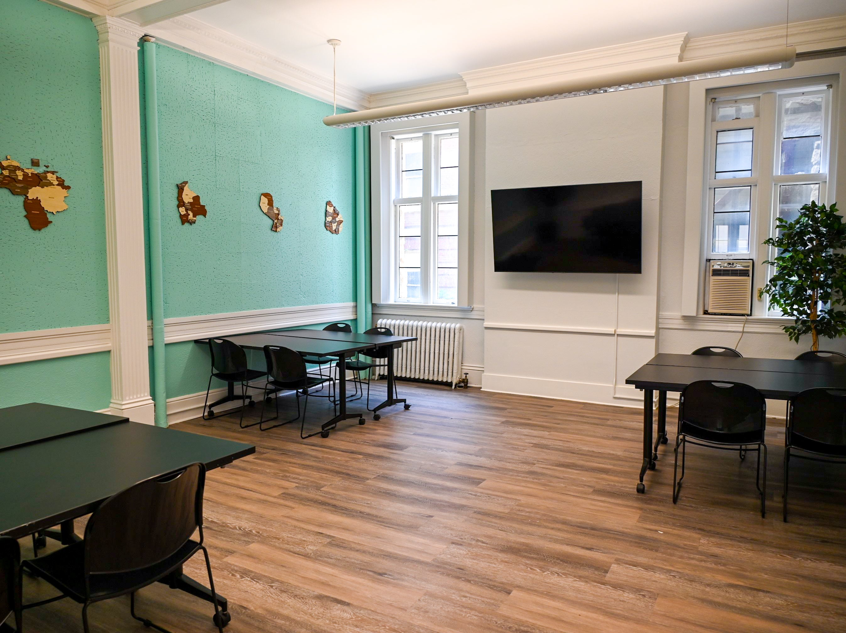 View of meeting room with three sets of tables and chairs