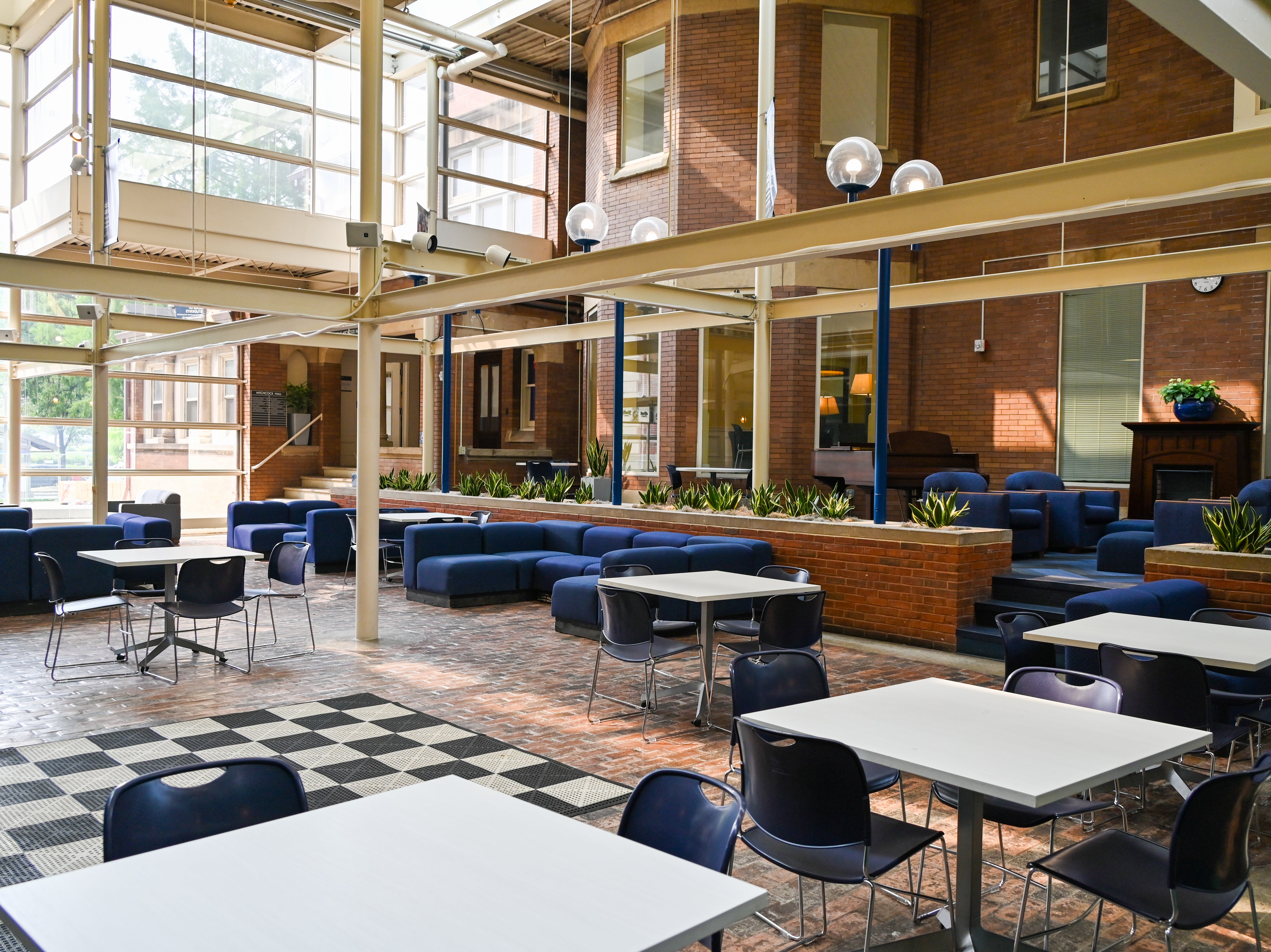 View of the Thwing Atrium with tables and chairs in the foreground