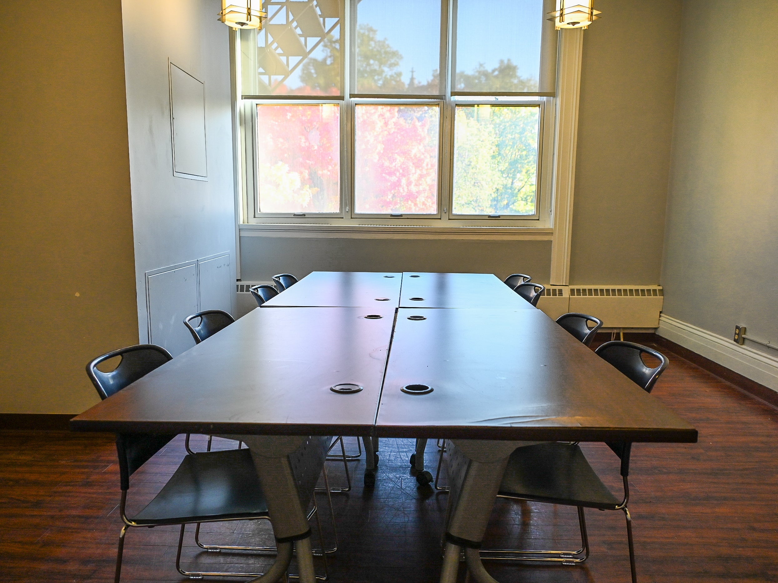 Empty Room 206 with a small conference table and chairs in the center of the room