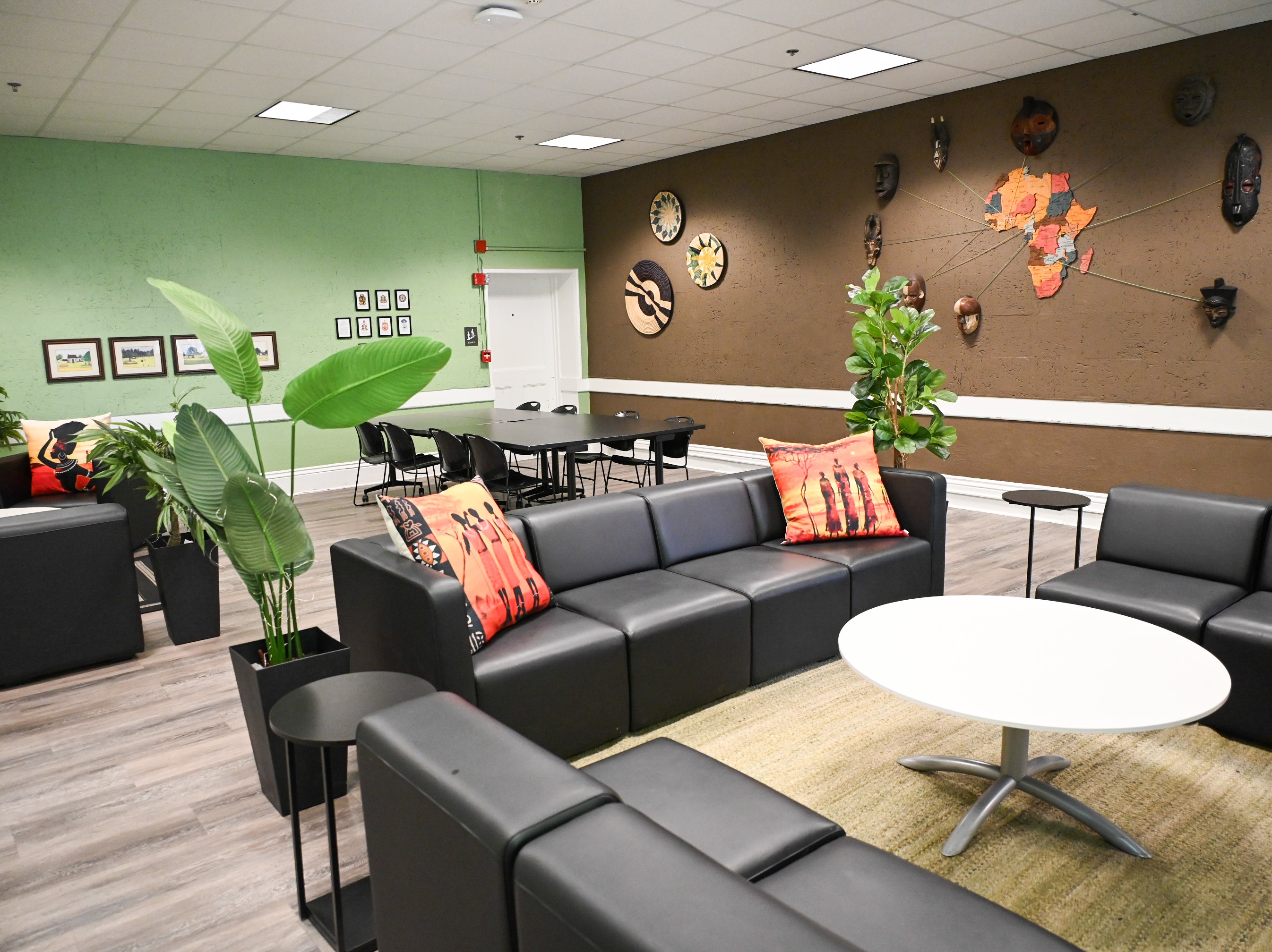 Furniture, plants and wall art in African American Room 103 in Eldred Hall