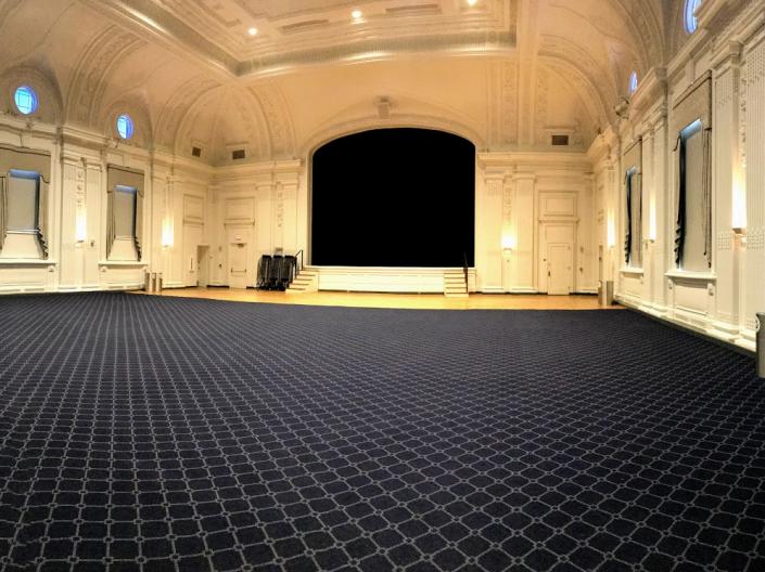 An empty view of Excelsior Ballroom with its large open floor and stage.