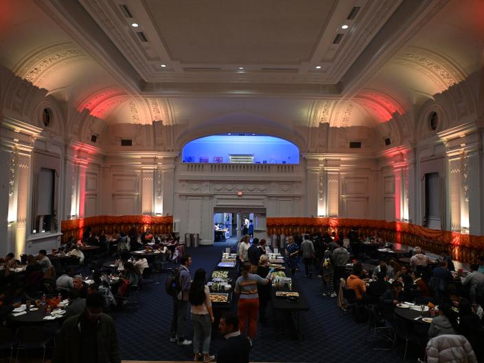 Wide Angle shot of students, faculty and staff at a dinner in the Thwing Ballroom