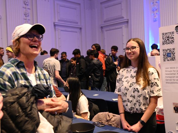 People smiling and laughing at event in Thwing Ballroom