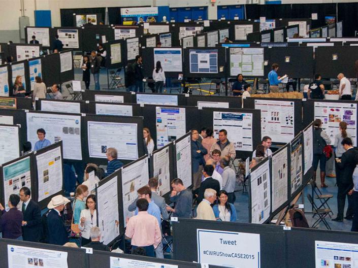 aerial view of intersections with rows of posters and presenters of research