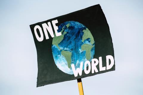 poster with earth that says "one world" 