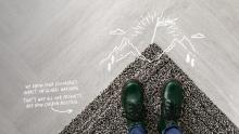 grey carpet with green shoes and white writing about carbon neutrality 