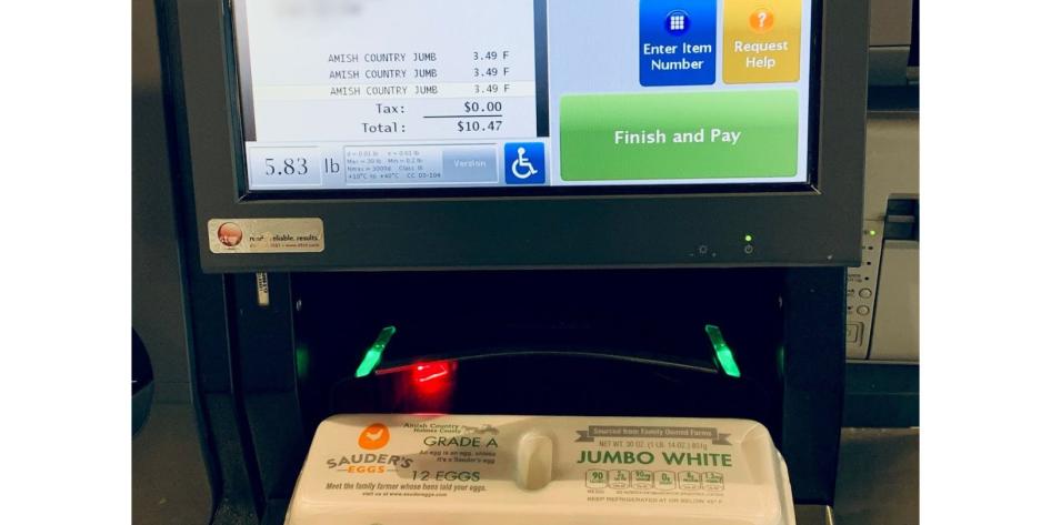 Photo at a grocery store checkout showing the cost of 3 carton of eggs is over ten dollars
