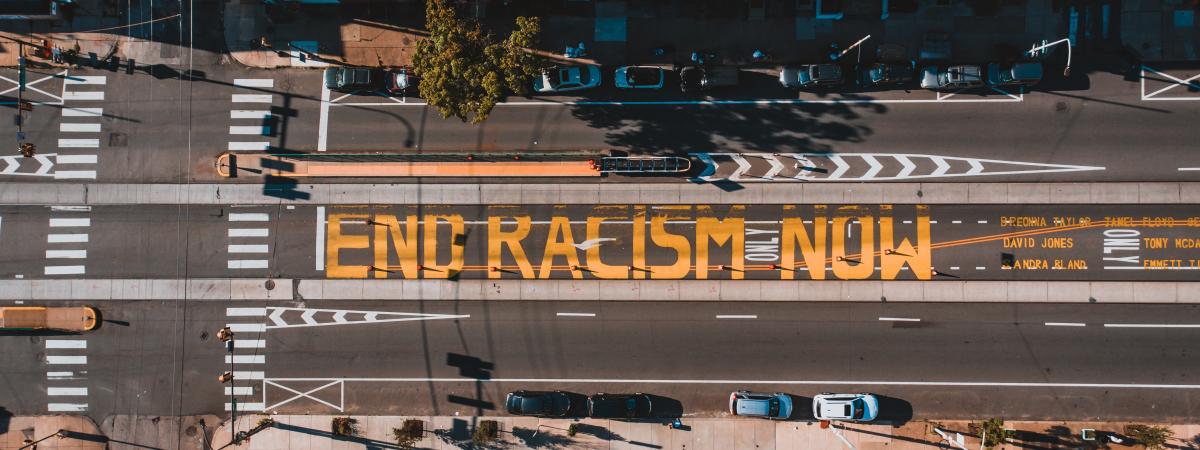 Street painted with words end racism now
