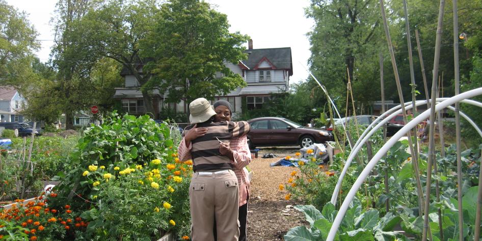 Two people hugging in the middle of a garden