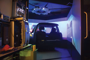Driving simulator made of numerous projectors and a speaker system.