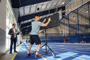Case Western Reserve University student Michael Tam testing his reaction time on the Reflexion Edge with Matt Campagna