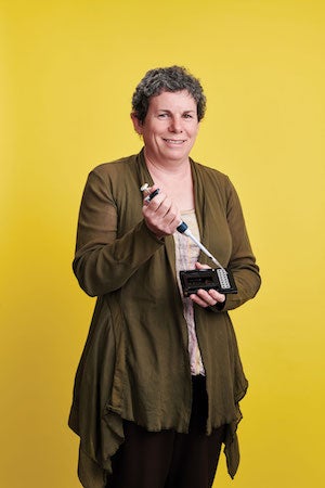 Case Western Reserve University Professor Susann Brady-Kalnay holding a pipette and cell tray.