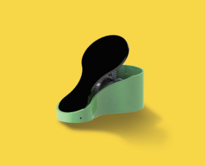 Green and black foot operated pedal that can produce enough electricity to charge a cell phone.
