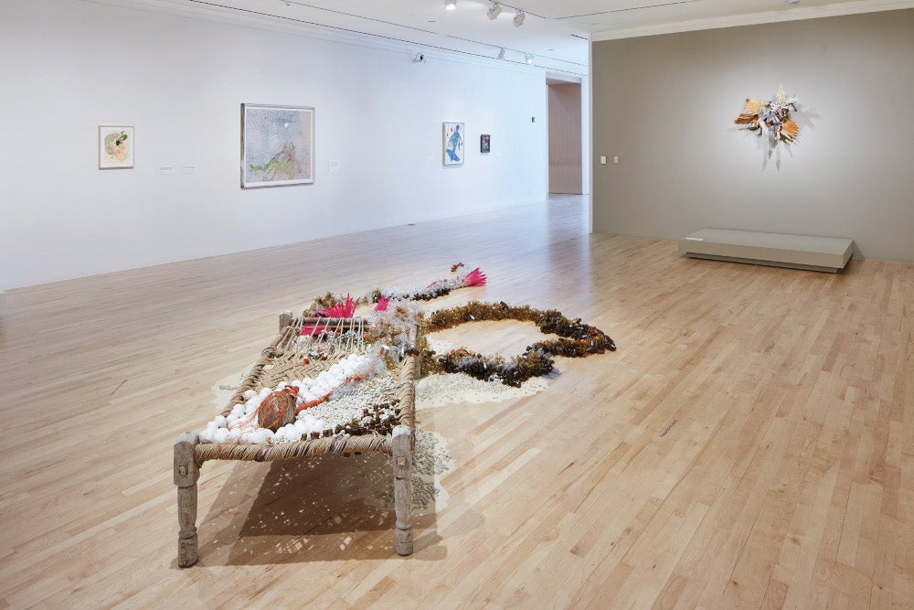 An art sculpture by Rina Banerjee displayed on a hardwood floor