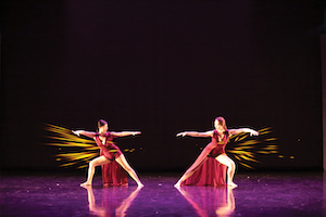 Two Case Western Reserve dancers mirror one another onstage
