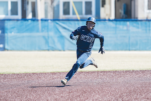 A Case Western Reserve student baseball player running around the bases