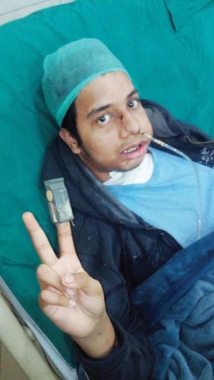Image of Talha Ali after his first surgery, lying down on a bed.