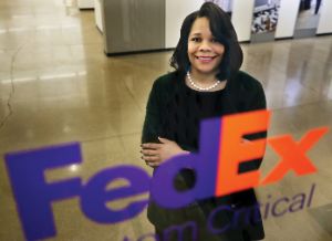 Ramona Hood standing behind a FedEx logo