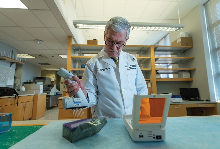 Mahmoud Ghannoum working in a laboratory