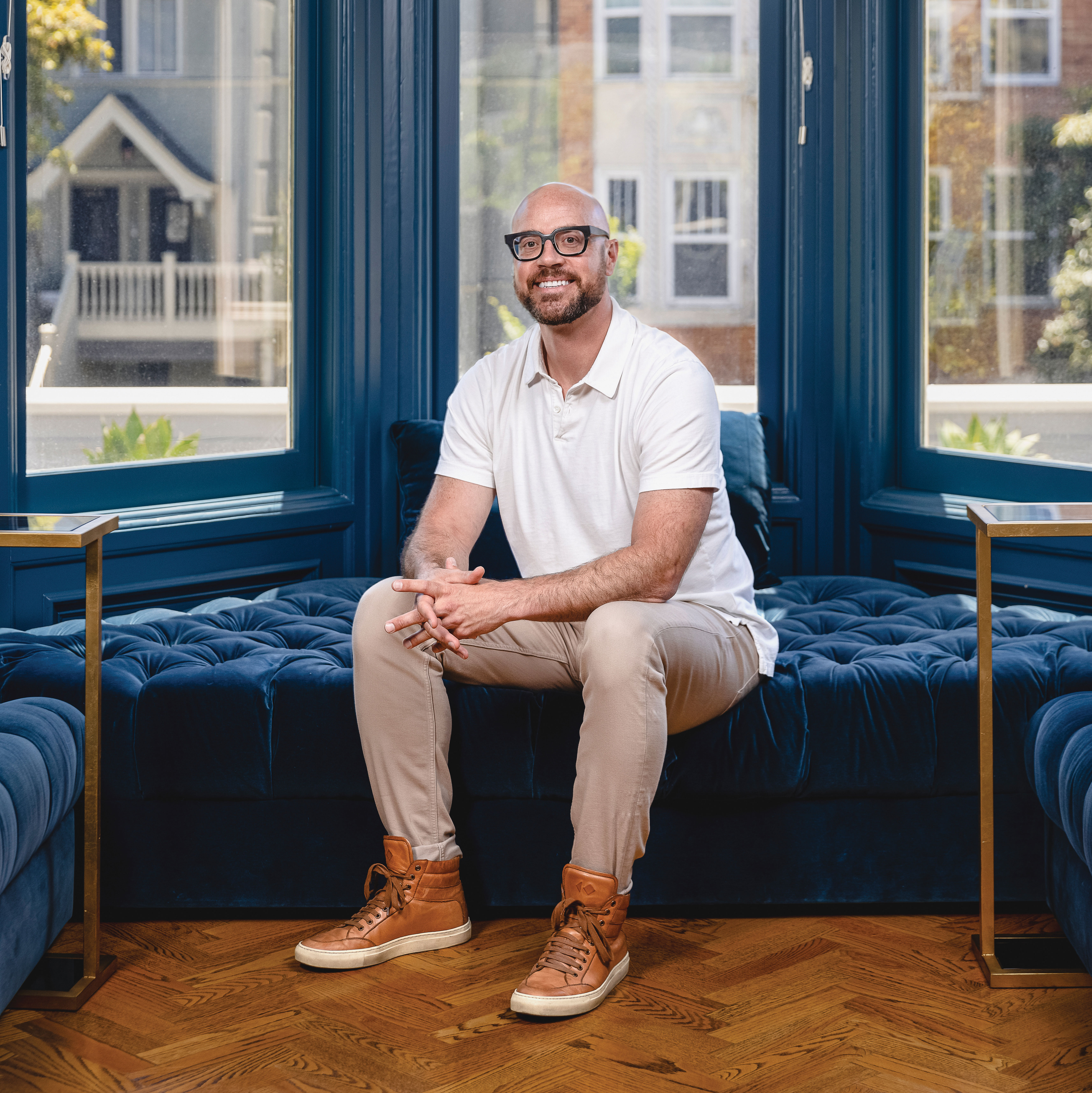 Full shot of John Kobs sitting on a cushion