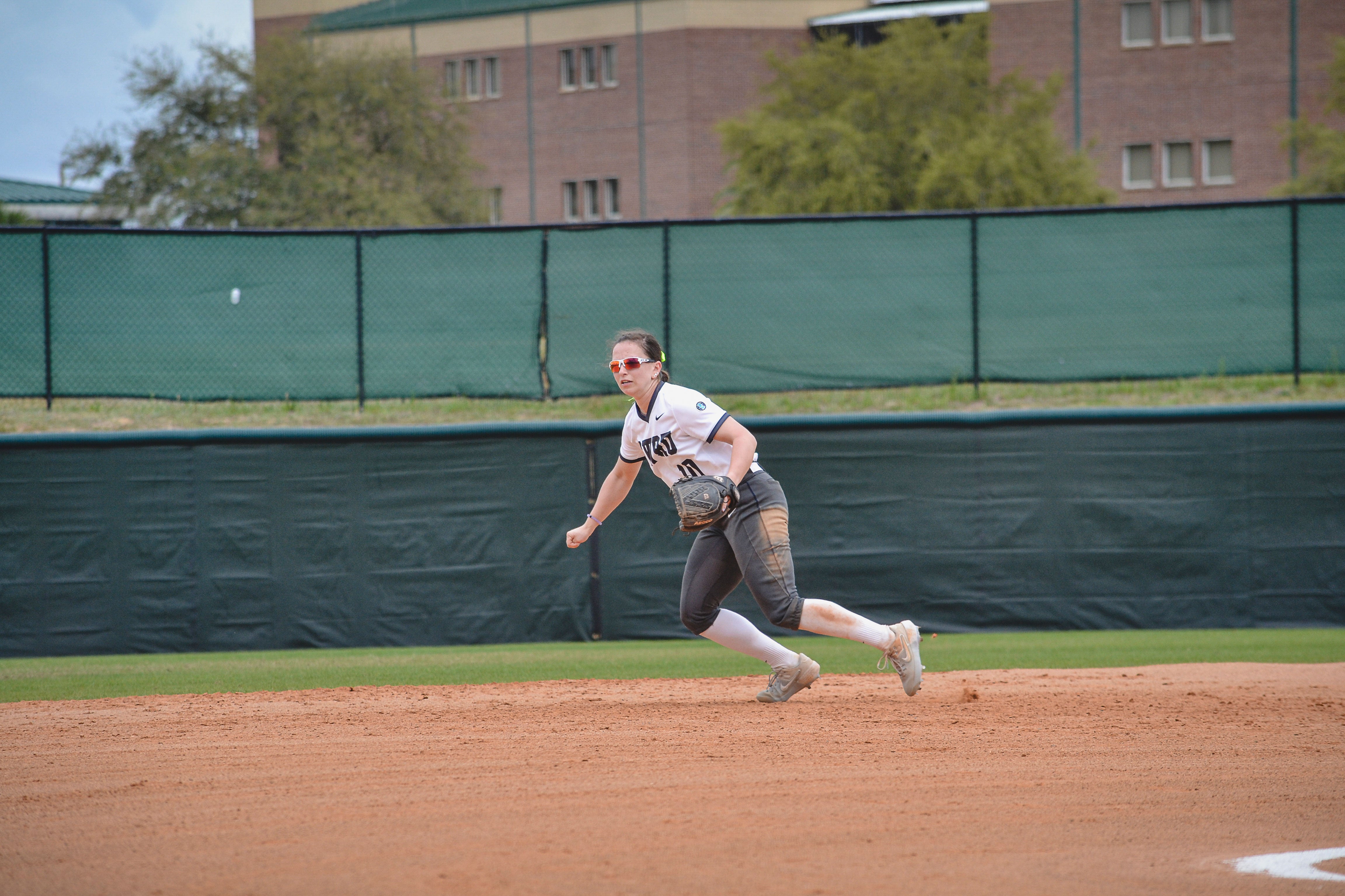 Sarah Miller playing softball in the outfield