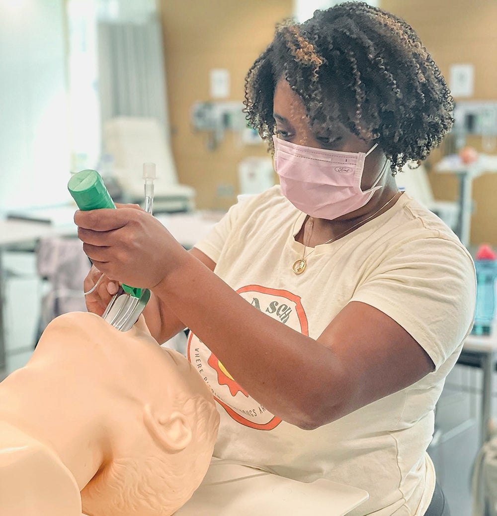 Photo of a Mya Williams working in a lab 