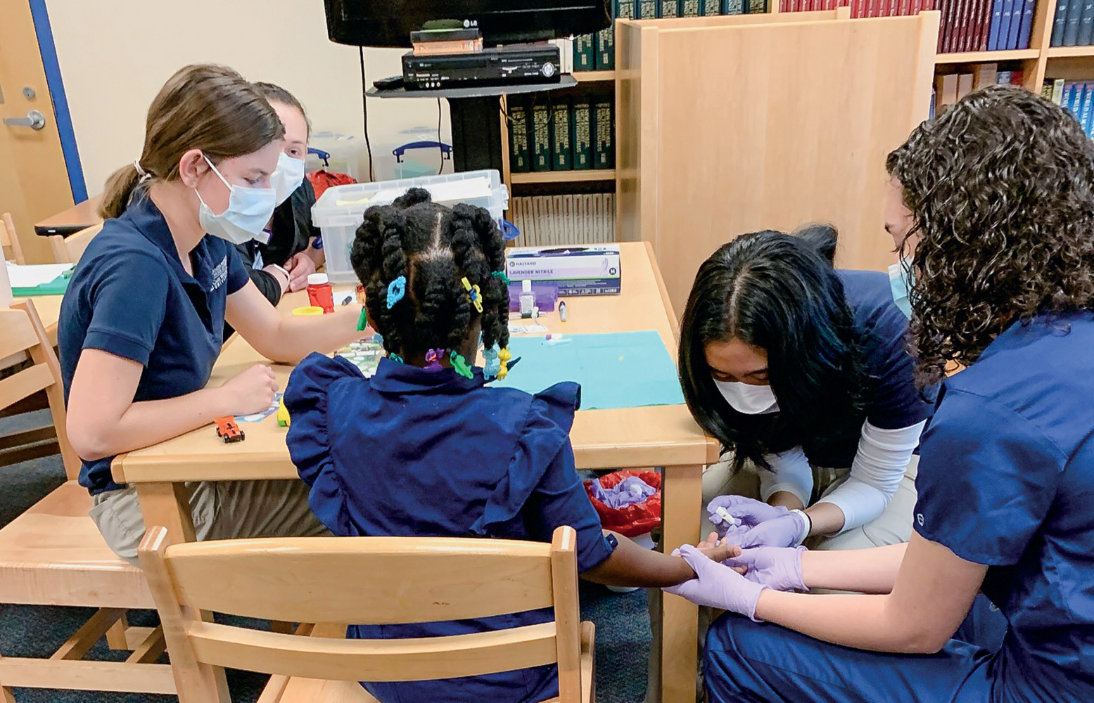 Photo of Case Western Reserve nursing students taking blood from a child to test for lead.