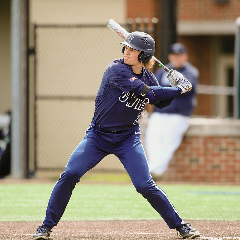 Nick Harms at home plate prepared to swing at a baseball.