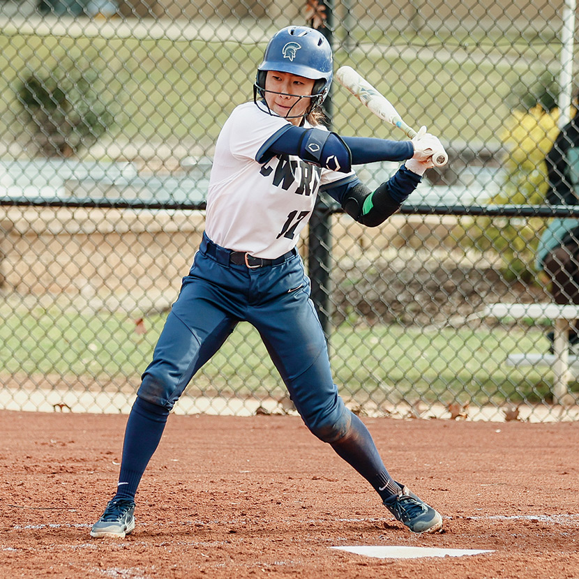 KaiLi Gross at home plate about to take a swing during a softball game.