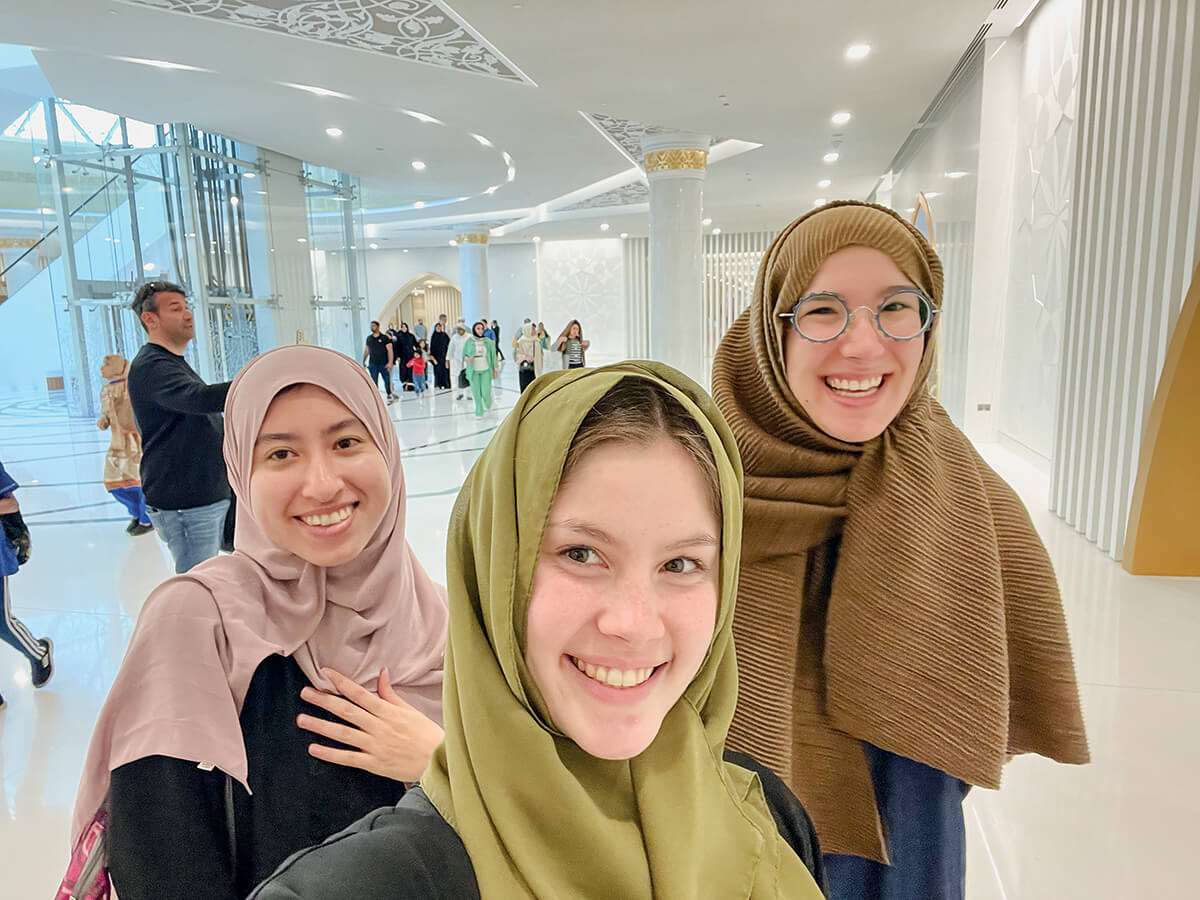 Photo of 3 students at the Grand Mosque in Abu Dhabi