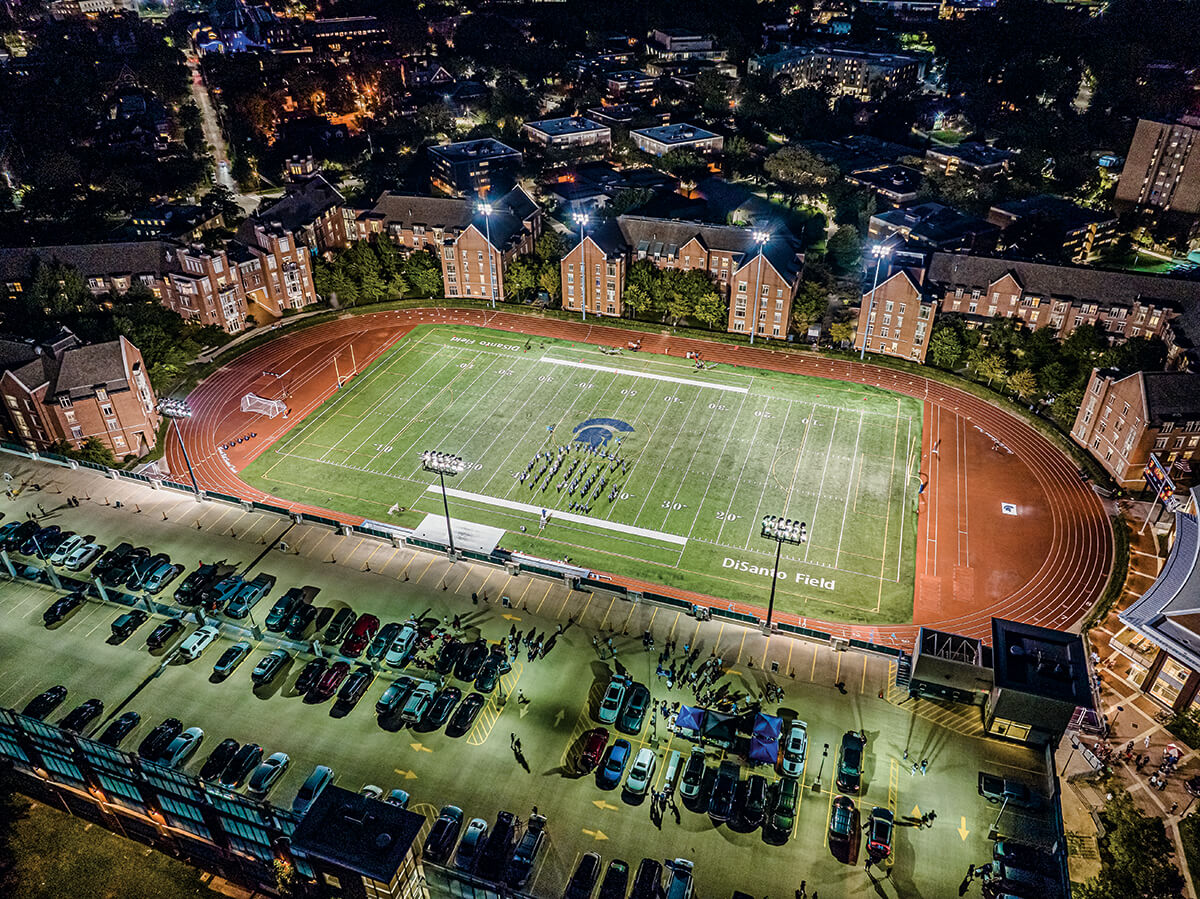 Aerial photo of DiSanto Field at Case Western Reserve in the evening with lights on.